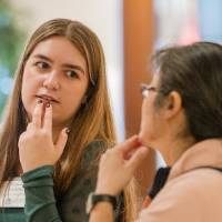 Aleksandra (left) talking to an attendee